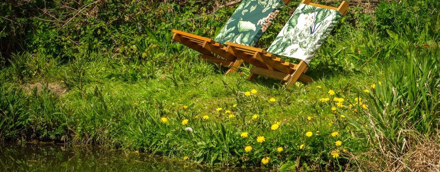Denys Fielding chairs by the river